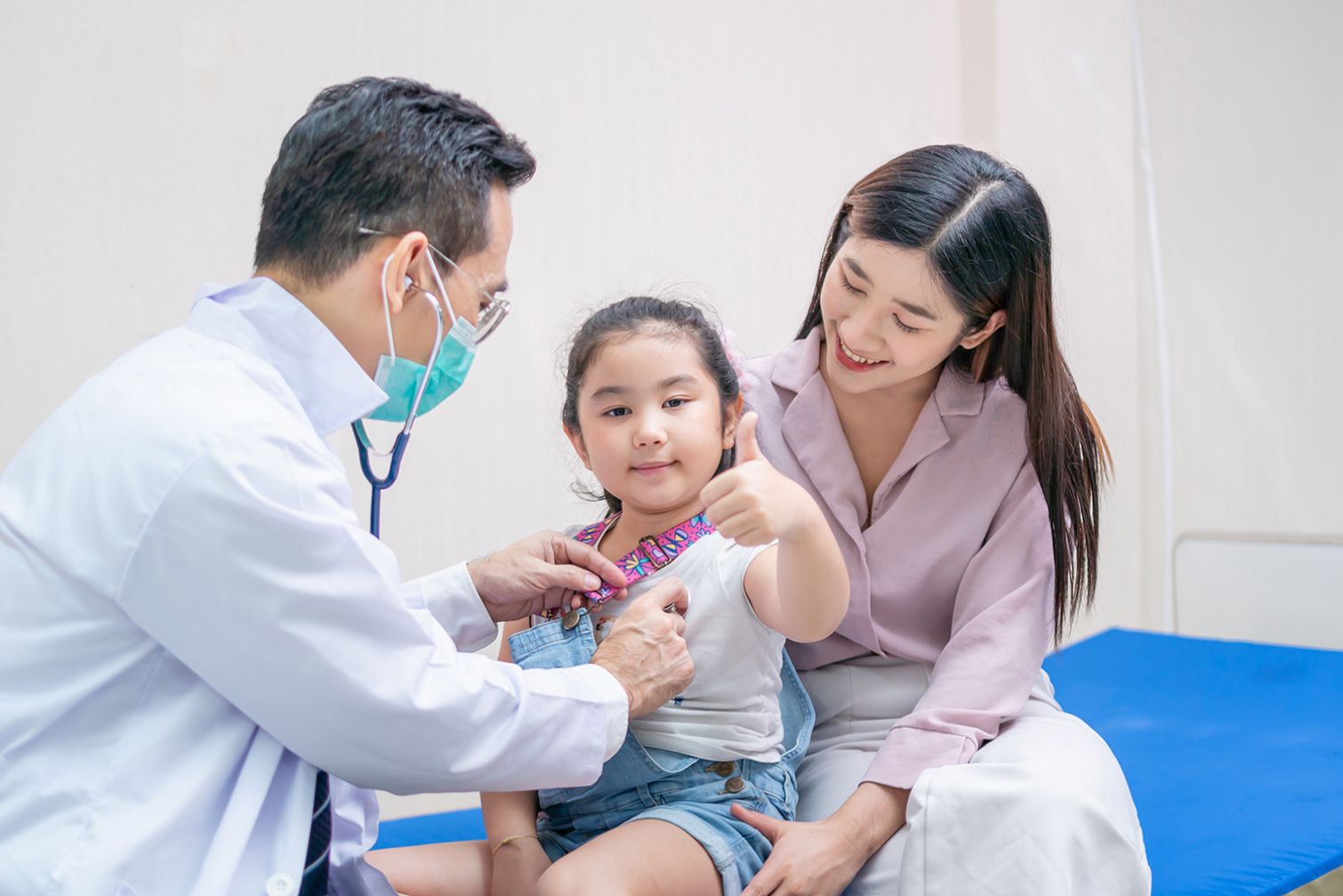 Happy child is examined by doctor
